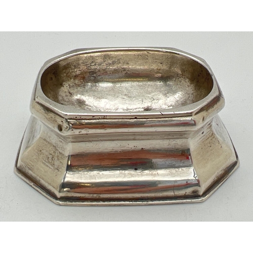 1169 - A George I silver trencher salt of octagonal form raised on a tapered base. Partially rubbed hallmar... 