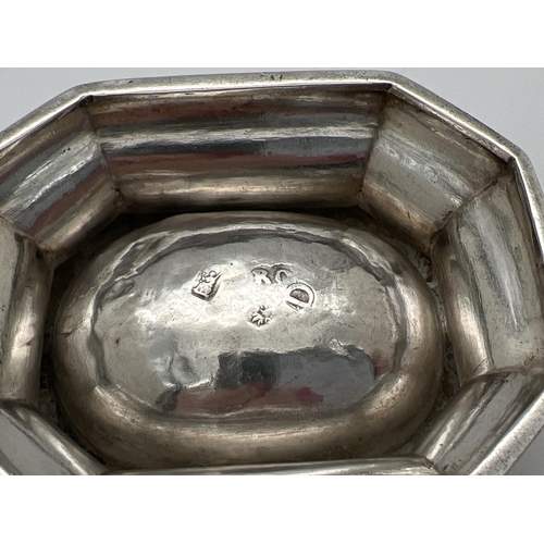 1169 - A George I silver trencher salt of octagonal form raised on a tapered base. Partially rubbed hallmar... 