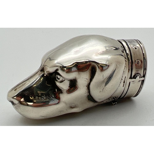 1171 - A novelty silver vesta case modelled as a dogs head, with striking panel to underside. Hinged lid in... 