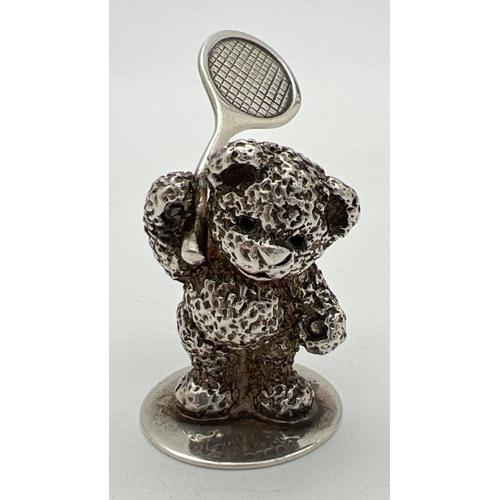 1174 - A small modern cast silver figurine of a teddy bear playing tennis. Hallmarked to base for Sheffield... 