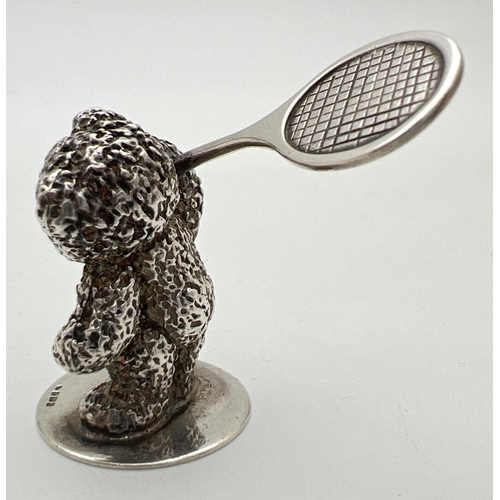 1174 - A small modern cast silver figurine of a teddy bear playing tennis. Hallmarked to base for Sheffield... 