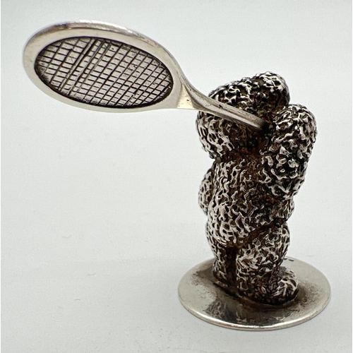 1174 - A small modern cast silver figurine of a teddy bear playing tennis. Hallmarked to base for Sheffield... 