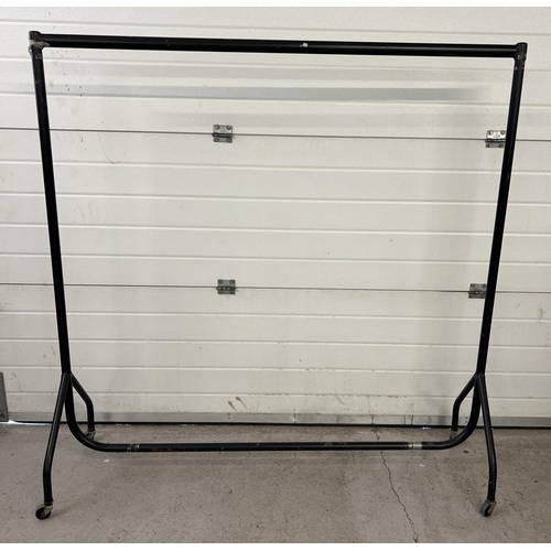 1430 - Heavy duty black coloured metal framed clothes rail on wheels. Approx. 155cm tall x 153cm long.