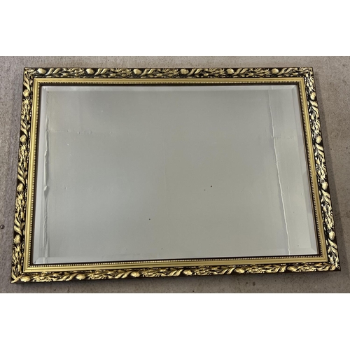 1507 - A large foliate design gilt framed wall hanging mirror, frame size approx. 71 x 101cm.