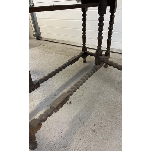 1510 - A vintage dark oak drop leaf, gate leg table with turned and bobbin design to legs and stretchers. F... 