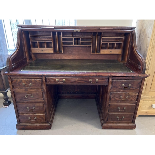 1514 - An Edwardian dark oak S bend roll top desk with 4 drawer twin pedestals. Interior has green leather ... 