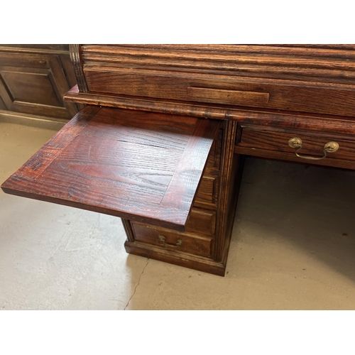 1514 - An Edwardian dark oak S bend roll top desk with 4 drawer twin pedestals. Interior has green leather ... 