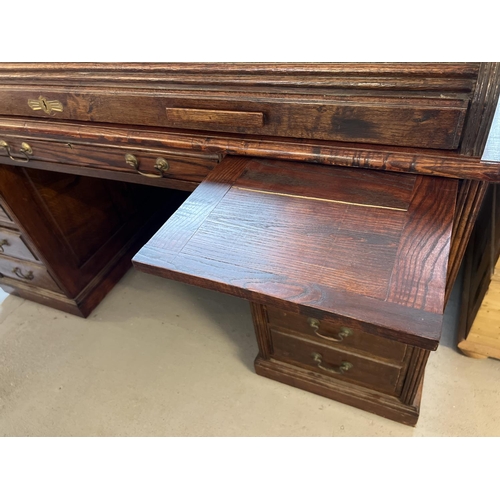 1514 - An Edwardian dark oak S bend roll top desk with 4 drawer twin pedestals. Interior has green leather ... 