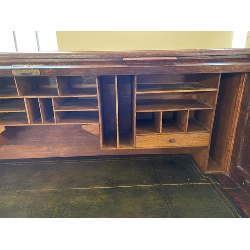 1514 - An Edwardian dark oak S bend roll top desk with 4 drawer twin pedestals. Interior has green leather ... 