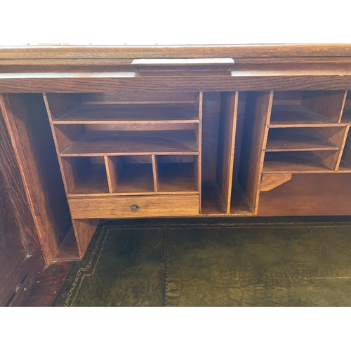 1514 - An Edwardian dark oak S bend roll top desk with 4 drawer twin pedestals. Interior has green leather ... 