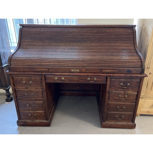 1514 - An Edwardian dark oak S bend roll top desk with 4 drawer twin pedestals. Interior has green leather ... 