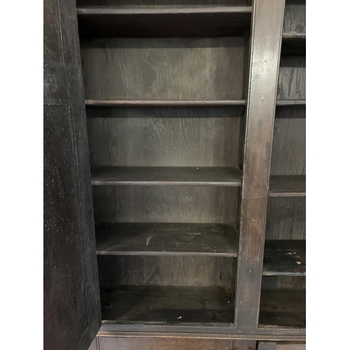 1518 - A Georgian dark wood 4 door cupboard with fixed interior shelves, raised on turned front legs. Origi... 