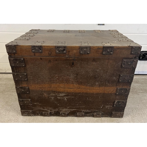 1520 - An antique dark wood storage chest with metal banding and drop down handles. Complete with lock, key... 