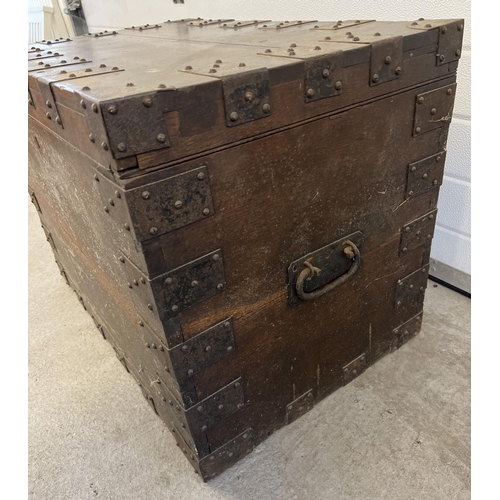 1520 - An antique dark wood storage chest with metal banding and drop down handles. Complete with lock, key... 