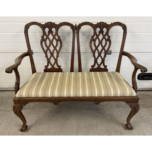 1521 - A late Victorian 2 seater satin wood settee with later striped upholstered seat. Ornately carved and... 