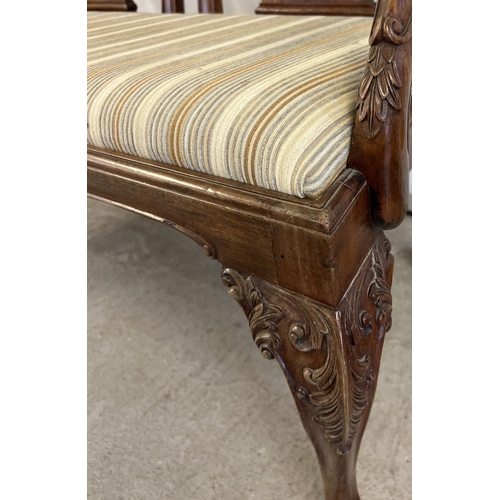 1521 - A late Victorian 2 seater satin wood settee with later striped upholstered seat. Ornately carved and... 