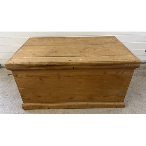 1523 - A large vintage pine blanket box with drop down handles to each end. Approx. 59cm x 112cm x 56cm.