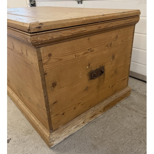 1523 - A large vintage pine blanket box with drop down handles to each end. Approx. 59cm x 112cm x 56cm.