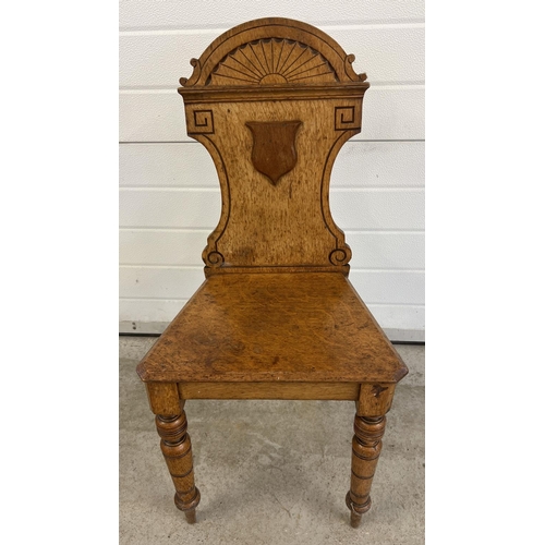 1527 - An Victorian light wood hall chair with turned legs and carved detail to back. Approx. 89cm tall.