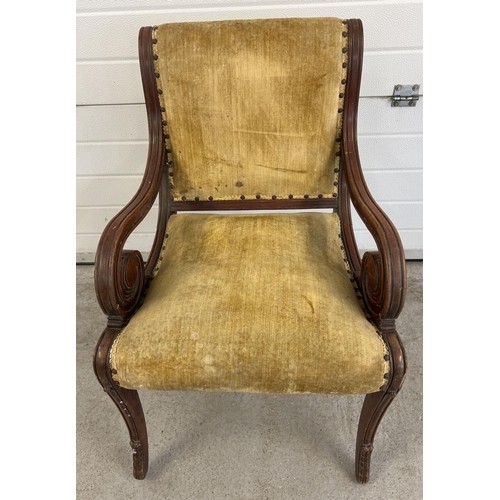 1528 - A Victorian wooden framed armchair with scroll detail to arms and carved legs. Velvet upholstered se... 