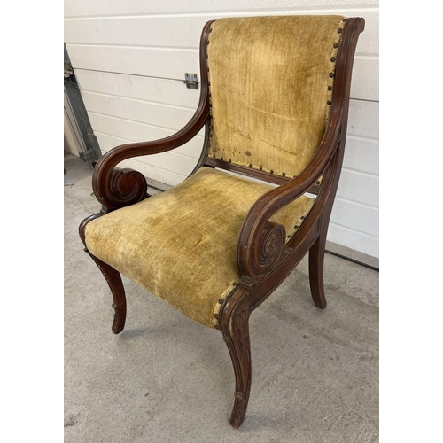 1528 - A Victorian wooden framed armchair with scroll detail to arms and carved legs. Velvet upholstered se... 