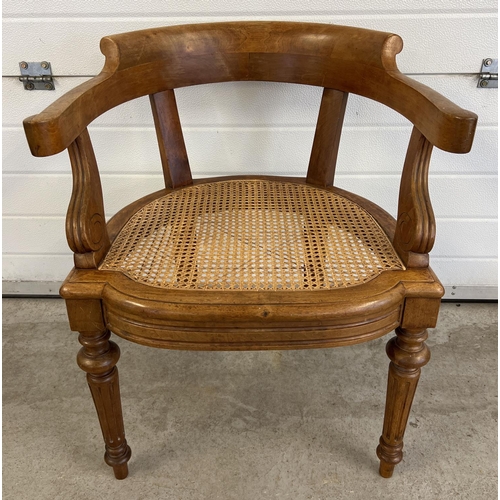 1535 - A Victorian light wood cane seated desk chair with curved back and turned legs.