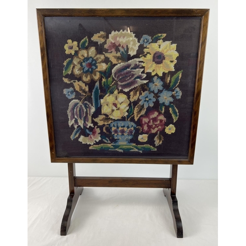 1536 - An Art Deco dark wood framed tilt top firescreen table with floral design needlepoint panel behind g... 