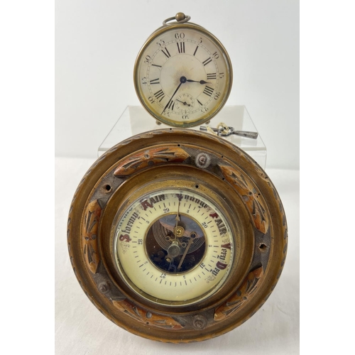 1256 - A vintage circular wooden barometer with carved detail together with a circular brass cased clock on... 