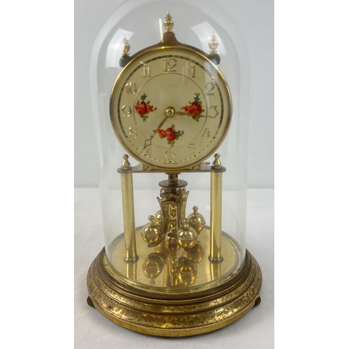 1257 - A vintage brass anniversary clock by Kundo W. Germany with glass dome. Floral detail to face with go... 