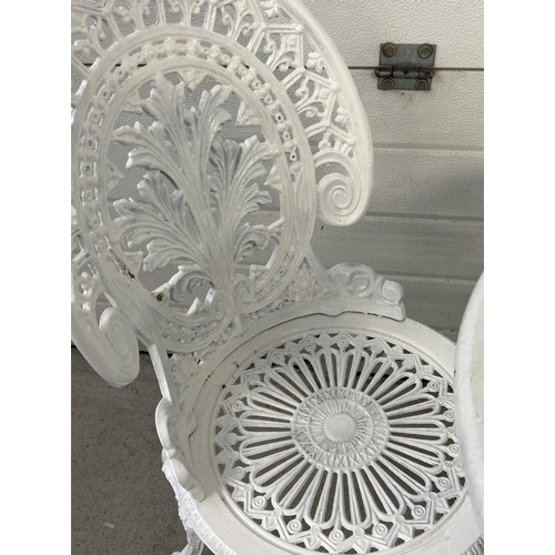 1485 - A cast metal 2 seat garden bistro set, painted white, with decorative pierced work detail. Table app... 