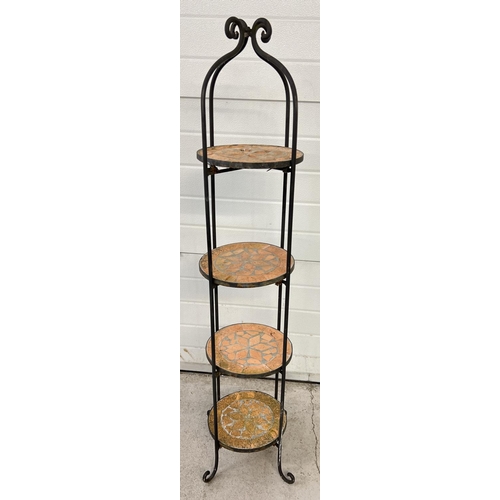 1486 - A large wrought iron framed, 4 shelf plant pot stand with shaped feet and top. 4 circular shaped rem... 