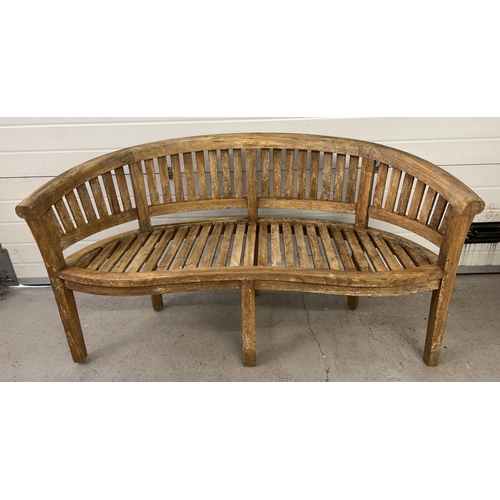 1487 - A large Windsor curve backed teak garden bench with slatted back and seat and serpentine shaped fron... 