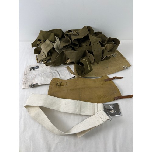 1208 - A small collection of military belts and canvas leg gaiters.