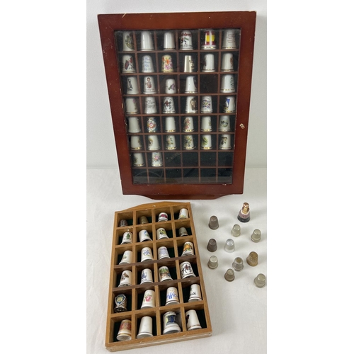 1303 - A collection of ceramic and metal thimbles in varying sizes and designs together with 2 small displa... 