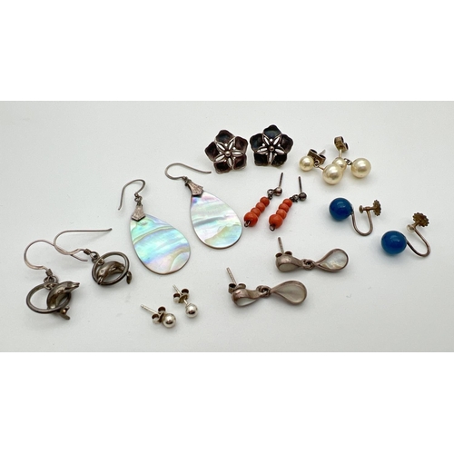 6 - 8 pairs of vintage and modern design silver and white metal earrings. To include large flower studs,... 