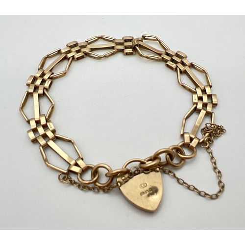 11 - A 9ct gold vintage 3 bar gate style bracelet with padlock clasp and safety chain. Gold marks to back... 