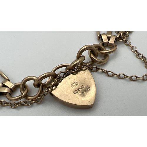 11 - A 9ct gold vintage 3 bar gate style bracelet with padlock clasp and safety chain. Gold marks to back... 