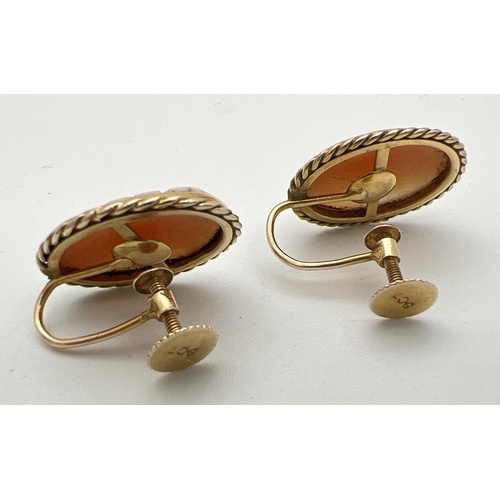 12 - A pair of 9ct gold oval shaped cameo stud style screw back earrings with rope design to mounts. Each... 