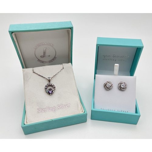 17 - 2 boxed items of silver jewellery. A stone set Claddagh pendant on an 18