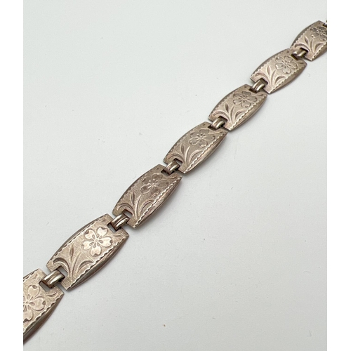 19 - A vintage silver 8 panel bracelet with flower engraved pattern to each panel and push clasp. Silver ... 