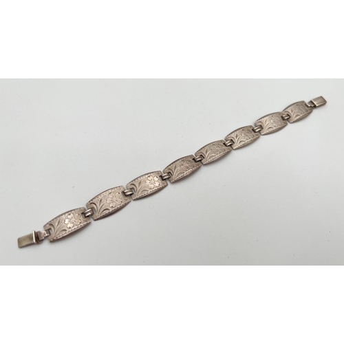 19 - A vintage silver 8 panel bracelet with flower engraved pattern to each panel and push clasp. Silver ... 