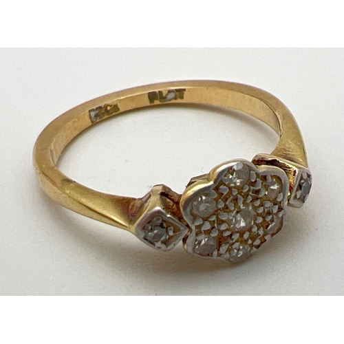 21 - An Art Deco 18ct gold and platinum diamond set ring. Floral style mount set with 7 small round cut d... 