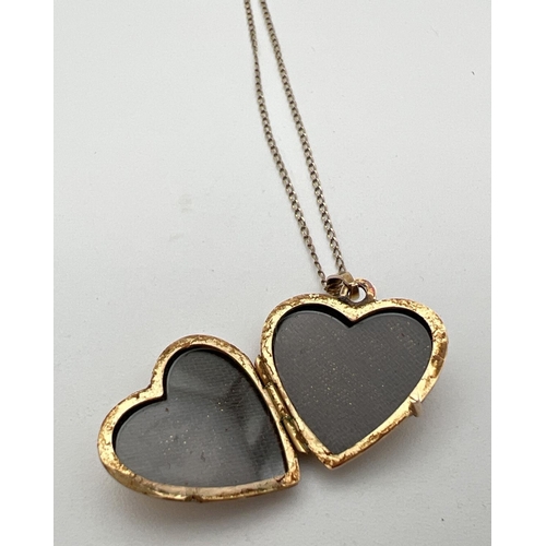 22 - A 9ct gold heart shaped locket with floral detail to front, on an 18