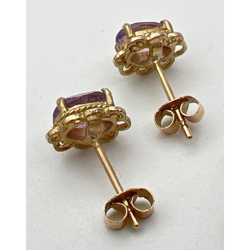 26 - A pair of gold & amethyst set stud earrings together with an oval amethyst set 9ct gold pendant. Hal... 