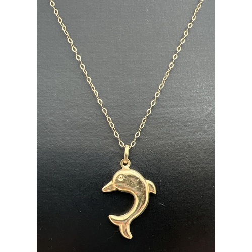 29 - A 9ct gold dolphin pendant on a 16