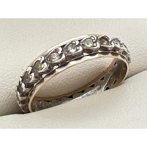 35 - A vintage 9ct gold & silver full eternity ring set with small round cut clear stones. In heart shape... 