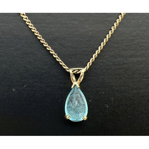 38 - A 9ct gold and blue topaz pendant necklace. Pendant set with a teardrop cut blue topaz, on a 16