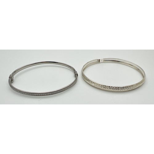 40 - 2 silver bangles, both with push clasps and safety clips. One with illusion stardust detail the othe... 