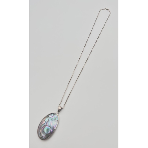 42 - An oval shaped Abalone shell pendant set in silver, on a 20