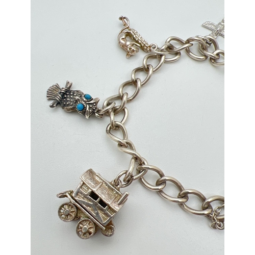 44 - A vintage silver charm bracelet with 6 charms, padlock and safety chain. Charms comprise: Wooden hou... 